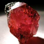 cover image of the article, showing a rough ruby gemstone